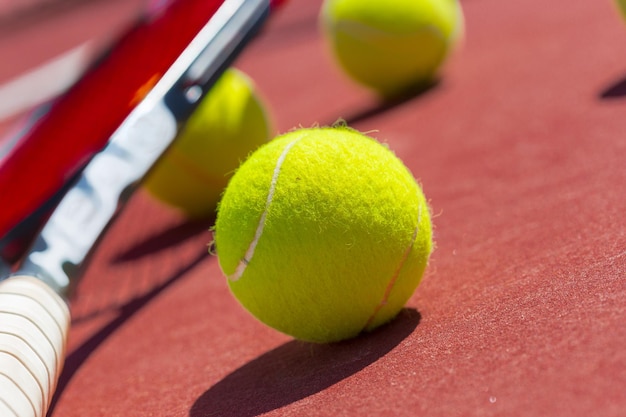 Tennis balls and racket on the grass court