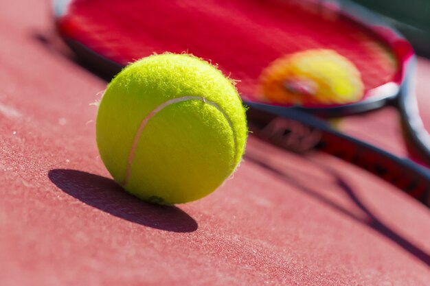 Tennis balls and racket on the grass court