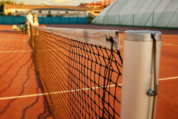 Tennis net on court in sunny day