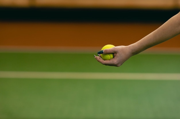 Tennis woman player playing training with racket and ball at court