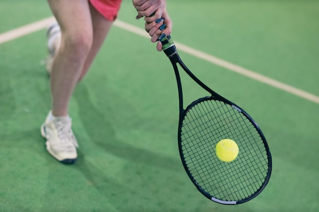 Tennis woman player playing training with racket and ball at court