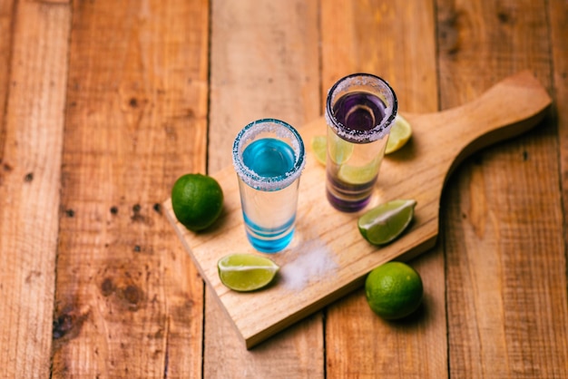 Tequila shots with salt and lime on a bar table