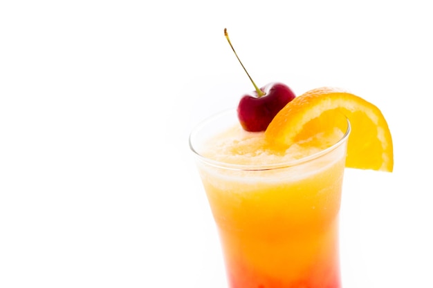 Tequila sunrise cocktail with orange wedge and cherry as a garnish.