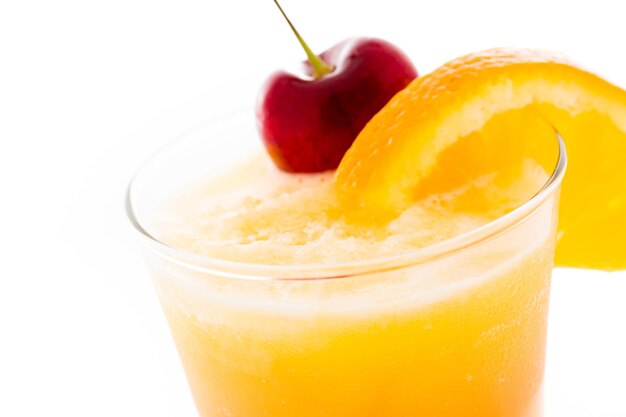 Tequila sunrise cocktail with orange wedge and cherry as a garnish.