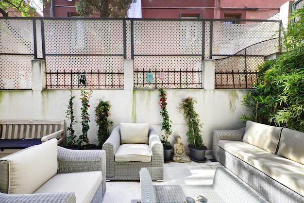 Photo terrace of a singlefamily home with a rattan lounge set with matching cushions and coffee table