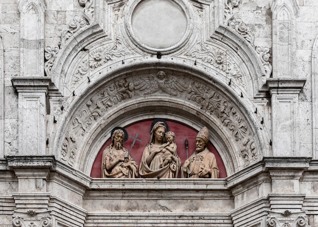 Terracotta relief in tympanum on Renaissance Sant Agostino church door, Montepulciano, Siena, Italy