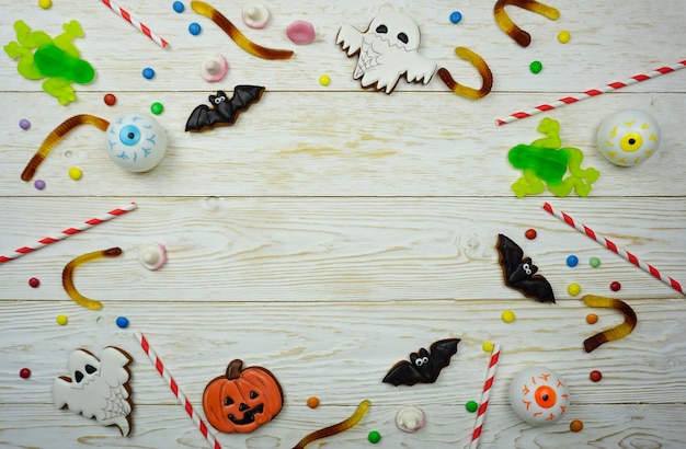 Terrible sweets are laid out on a wooden table to celebrate Halloween