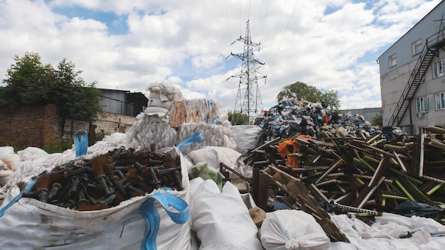 On the territory of the recycling plant, large heaps of plastic canisters and boxes, ecology concept