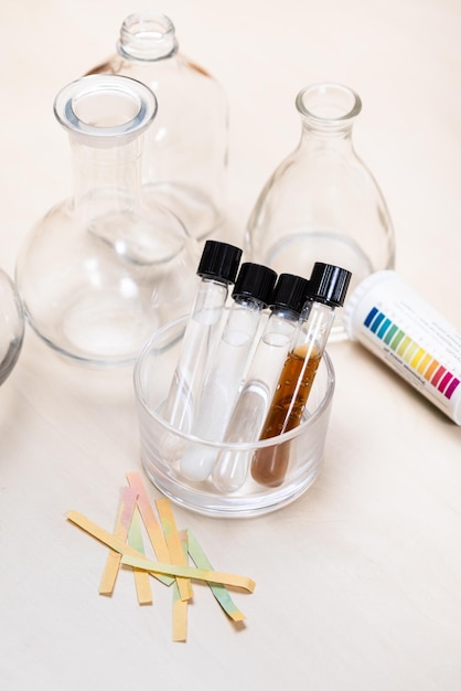 Test tubes with liquids flask and indicator paper