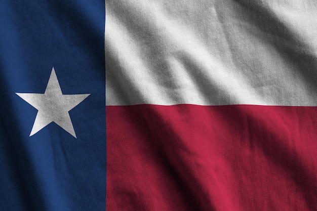 Texas US state flag with big folds waving close up under the studio light indoors The official symbols and colors in banner