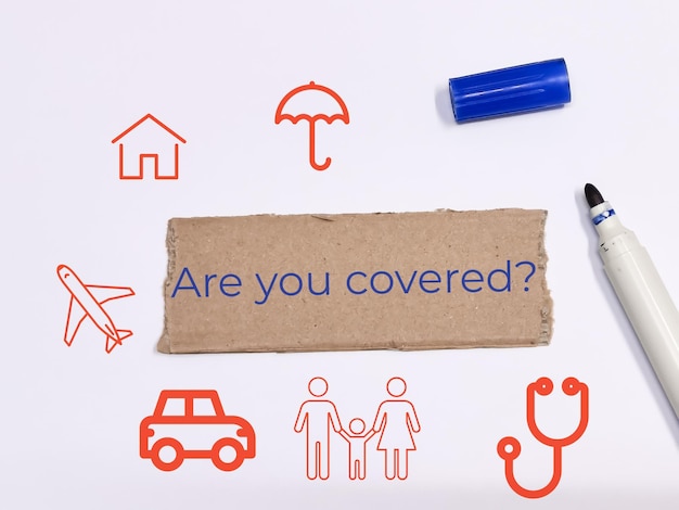 Photo text are you covered written on brown paper strip insurance concept