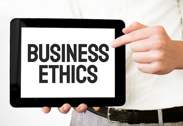 Photo text business ethics on white paper plate in businessman hands on the white bakcground. business concept