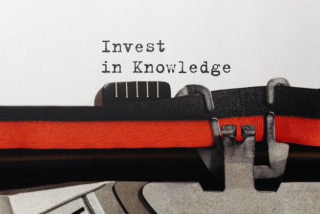 Text Invest in Knowledge typed on retro typewriter