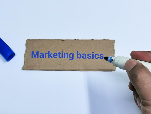 Photo text marketing basics written on brown paper strip against white background