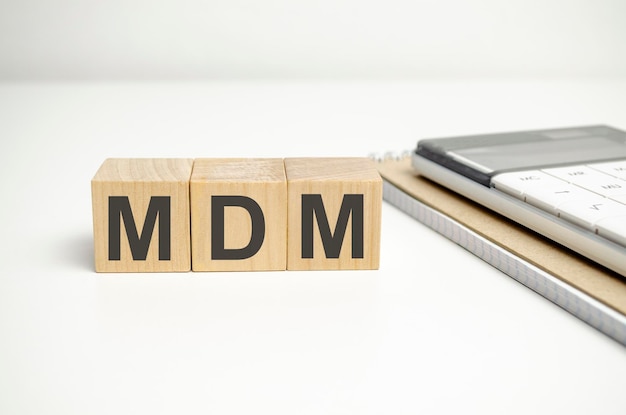 Text MDM as MOBILE DEVICE MANAGEMENT on wooden blocks