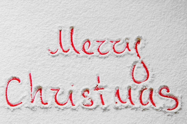 Text Merry Christmas on the snowy background