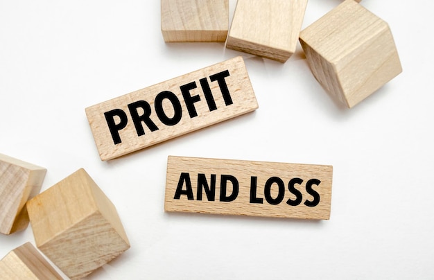 Text profit and loss on wooden blocks concept business succeed