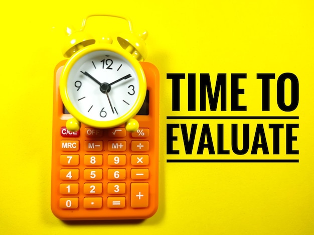 Text TIME TO EVALUATE with clock and calculator on yellow background