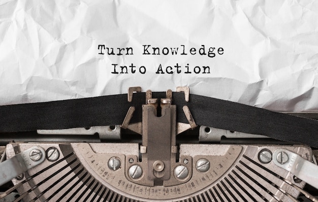 Text Turn Knowledge Into Action typed on retro typewriter