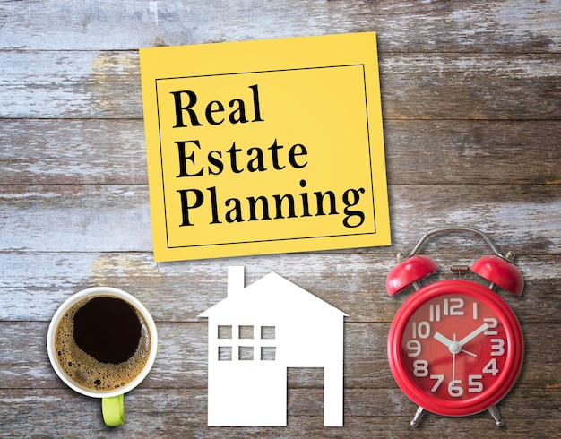 Text with real estate planning write on a yellow sticky note