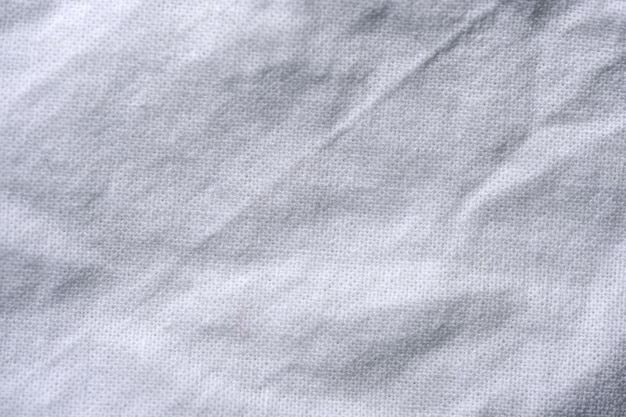 Textile background from a gray textured tablecloth close-up