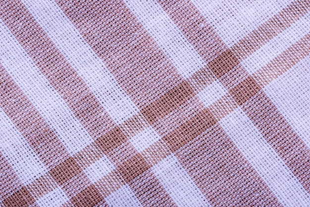 Textile background from a red textured tablecloth close up