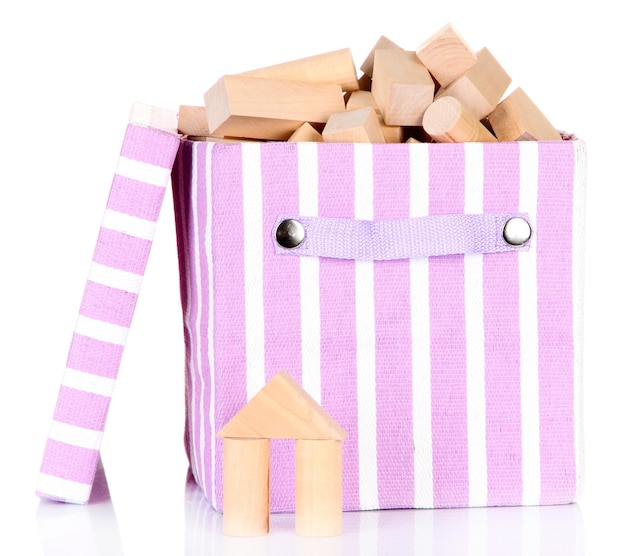 Textile box with wooden building kit isolated on white