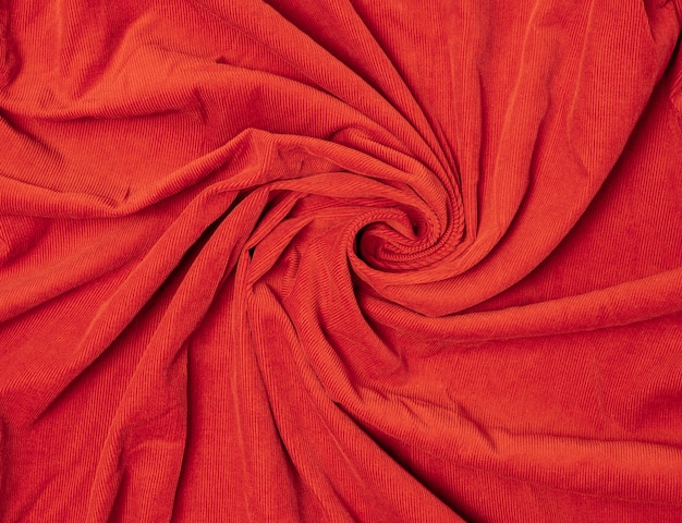 Textile and fabric concept background orange velvet fabric cloth texture soft texture with spiral