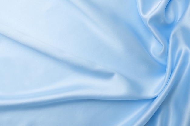 Textile and texture concept of trendy classic blue color . Sample of wavy silk fabric of classic blue color - closeup.