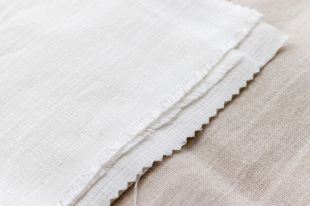 Textural background of two types of natural linen fabric lying on top of each other