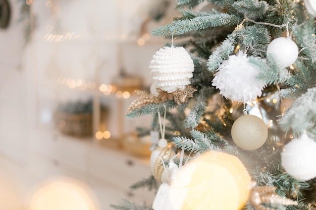 texture background Christmas tree branch with toy. white toy with patterns. festoon light bulb