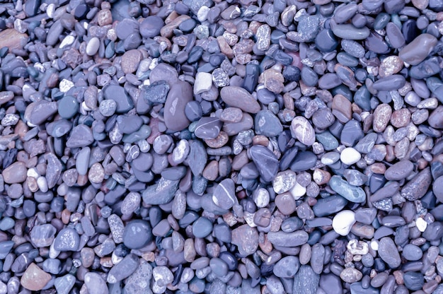 Texture background in color of 2022 purple texture background pebbles on beach space for text