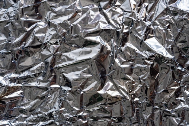 Texture background of crumpled silver foil plastic. Concept of global warming.