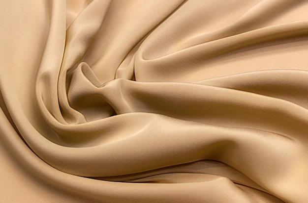 Texture, background, pattern. Texture of beige silk or cotton or wool fabric. Beautiful pattern of fabric.