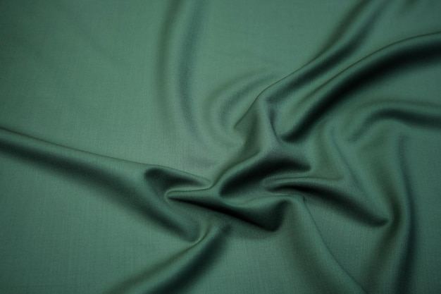 Texture background pattern Texture of green silk fabric Beautiful emerald green soft silk fabric