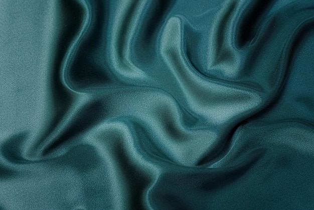 Texture background pattern Texture of green silk fabric Beautiful emerald green soft silk fabric