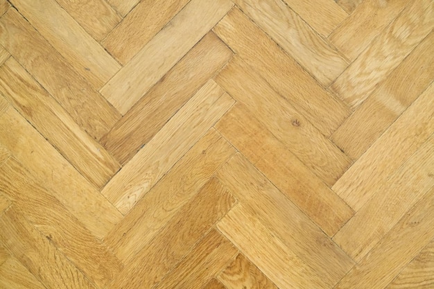 Texture background, vintage wooden parquet herringbone, top view.