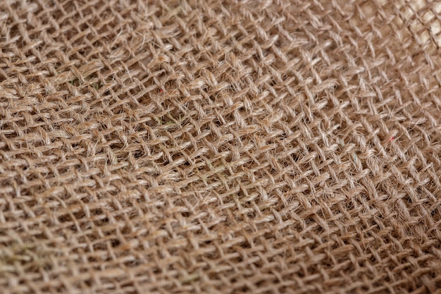 Texture of beige brown canvas fabric close-up background