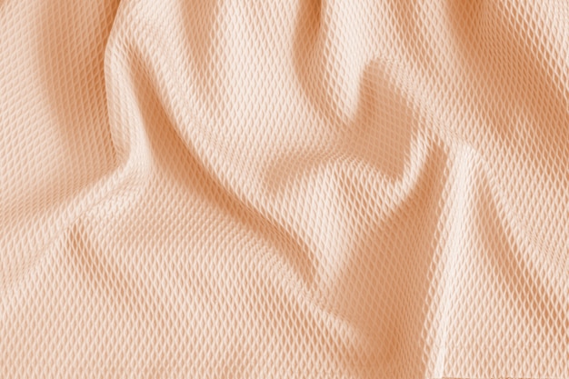 Texture of beige fabric with structure. Patterned fabric