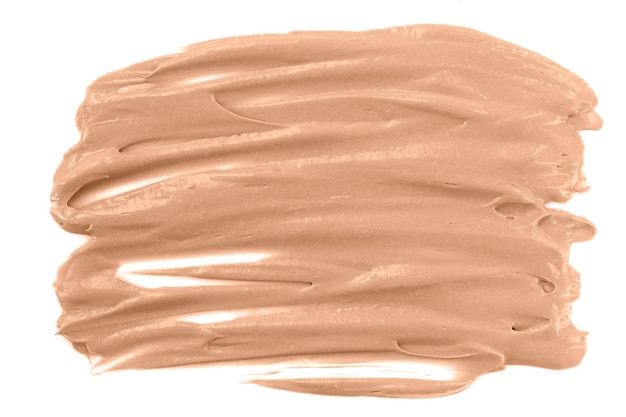 Texture of beige liquid tone cream foundation isolated on white