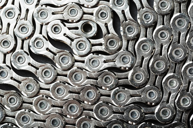 The texture of a bicycle chain is a closeup of the torque transmission links in full screen