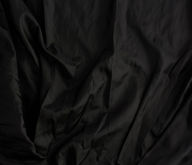 Texture of black cotton fabric with waves, full frame