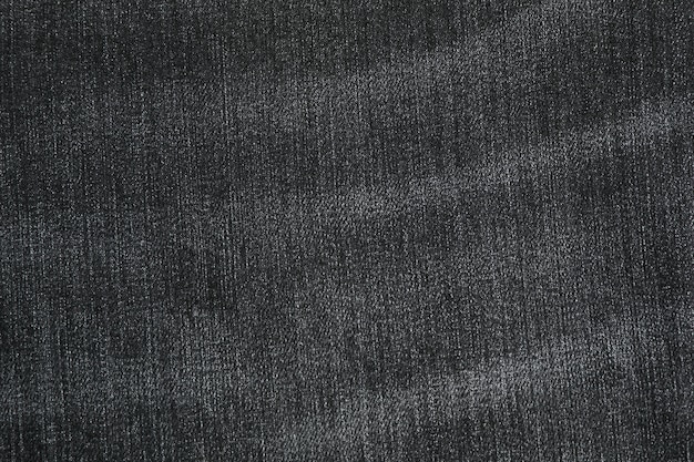 Texture of black jeans as background, space for text