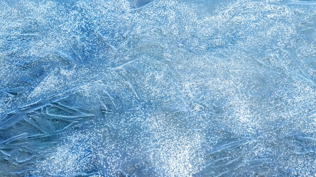 Texture of blue ice on the river in sunny weather