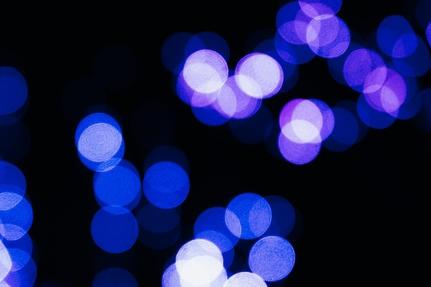 Texture of blurred colored lights on a black background