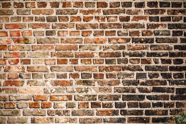 The texture of a brick wall covered with black soot.