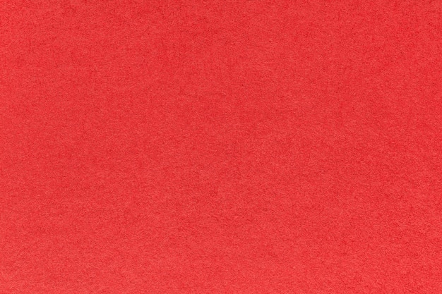 Texture of bright red and ruby colors paper background macro Structure of dense craft garnet cardboard