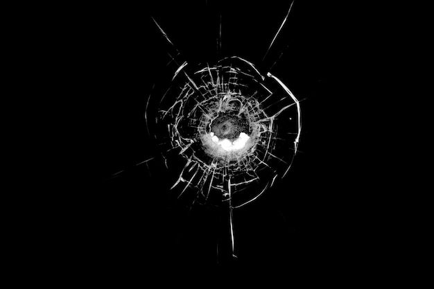 Texture of broken glass Hole from a ball on a black background