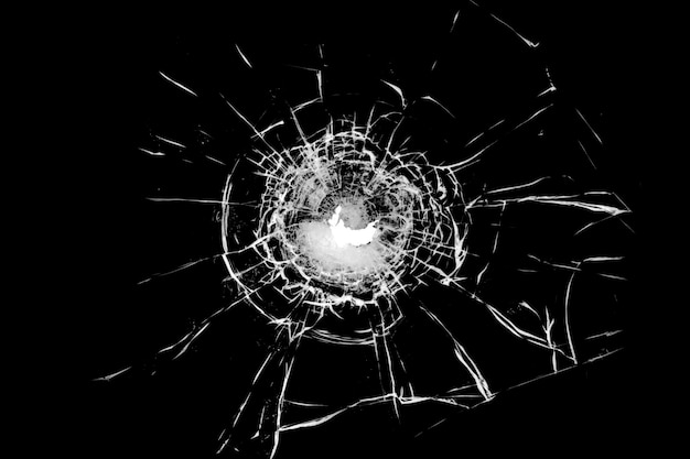 Texture of broken glass Hole from a ball on a black background