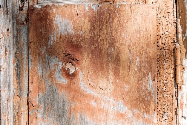 Texture of brown old shabby wood wall with peeling and cracked paint